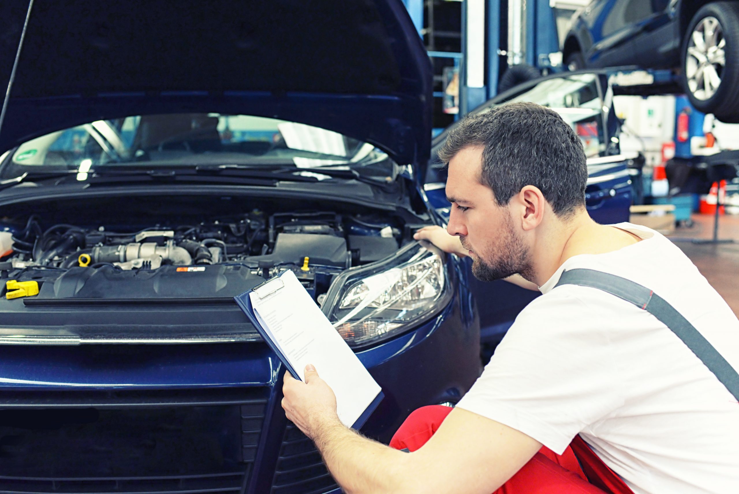 Mechanic looking at paper checklist