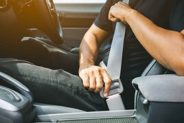 Person putting on seatbelt
