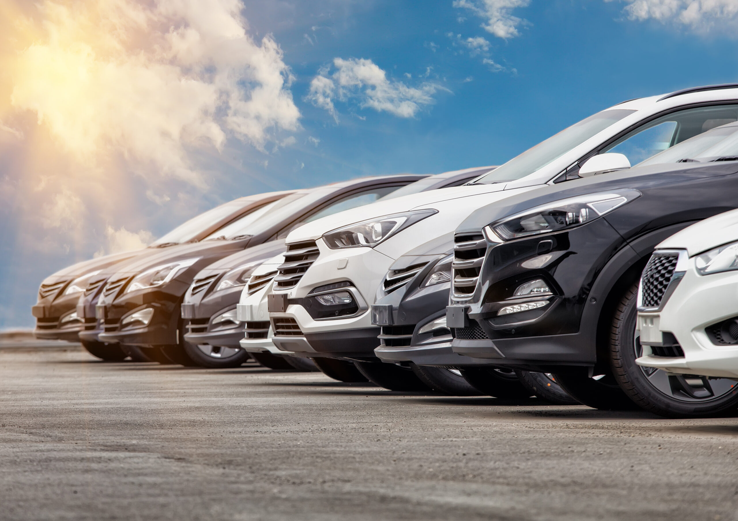 Cars lined up with blue sky background