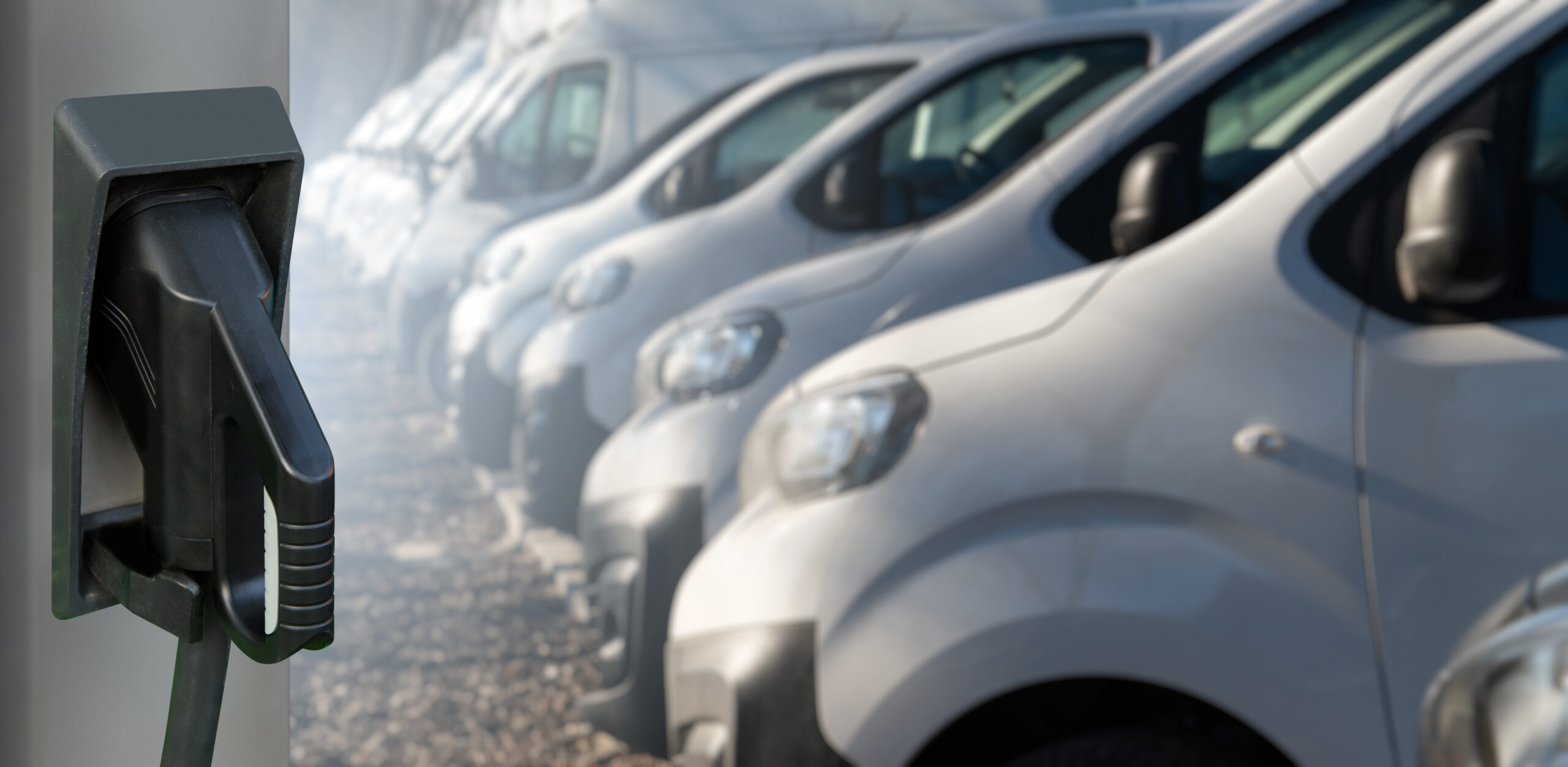 Vans lined up with EV charger